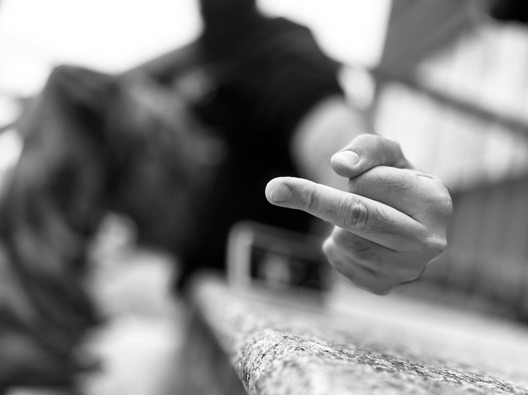 Close-up of a hand pointing at printed charts during a newsroom discussion