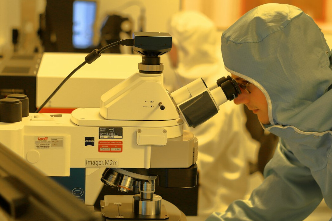 Journalist analyzing data charts and documents at a desk